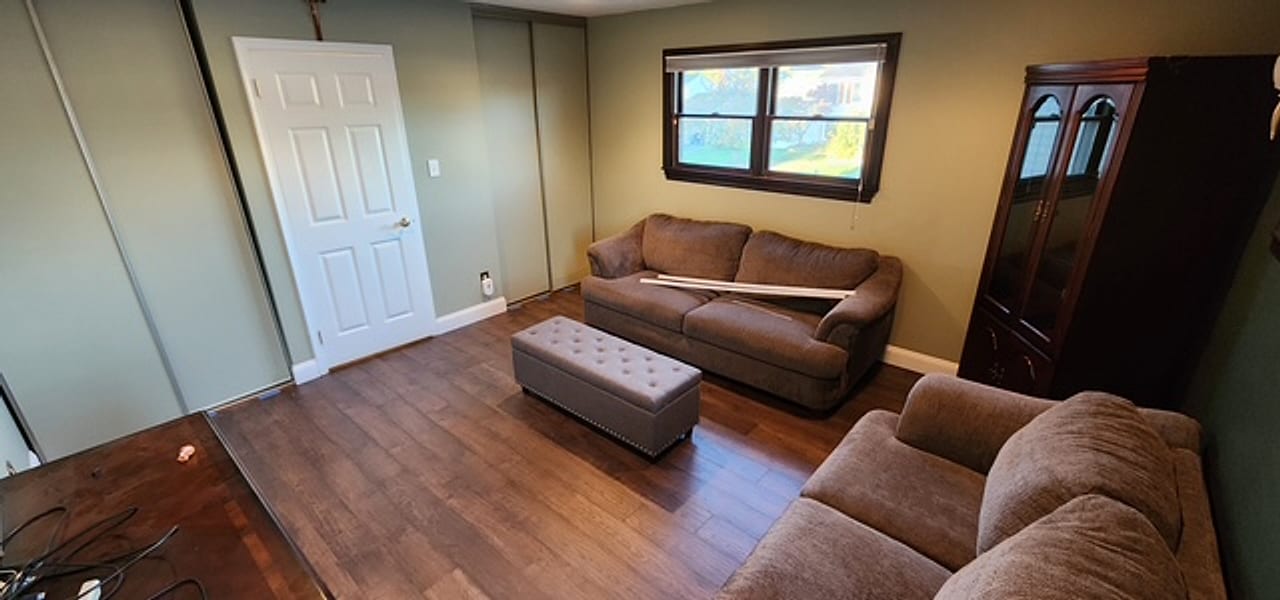 Dark rustic plank flooring installed in a family den by Frankie D&rsquo;s Flooring