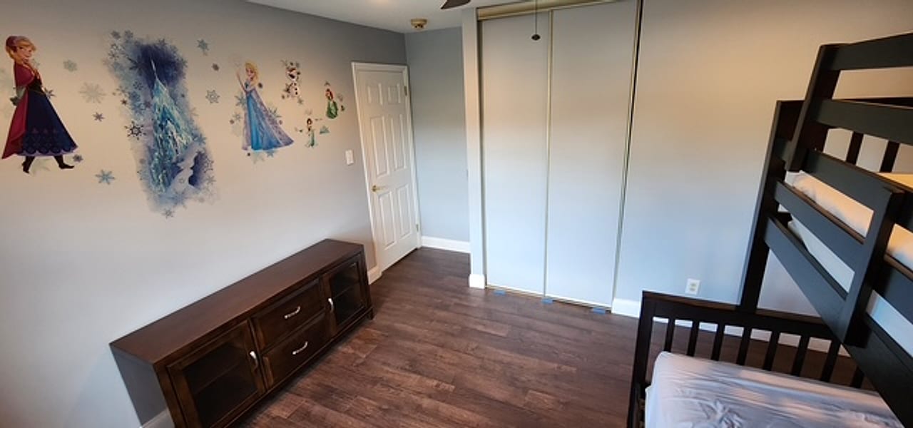 Dark plank flooring running into the closet of a kids&rsquo; bedroom by Frankie D&rsquo;s Flooring
