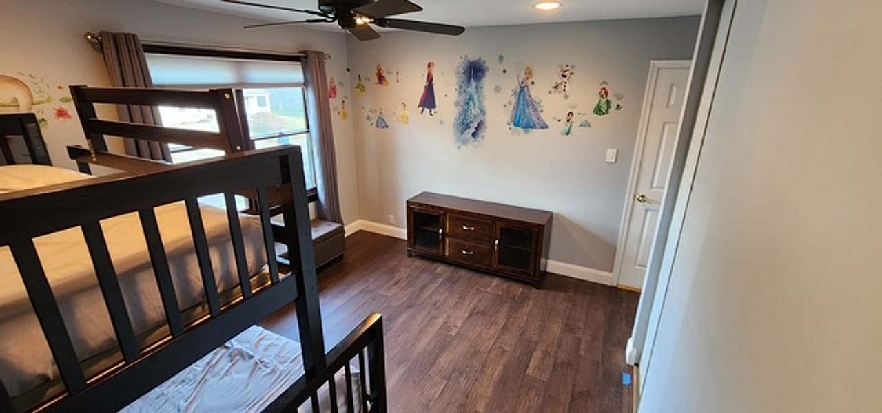 Dark plank flooring wall to wall in a kids&rsquo; bedroom by Frankie D&rsquo;s Flooring