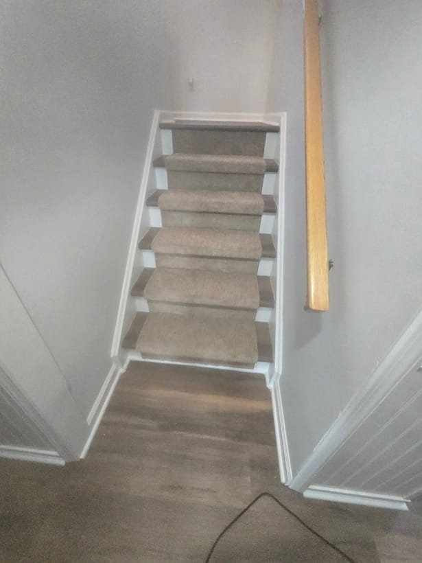 Carpet stair runner down to a hardwood landing by Frankie D&rsquo;s Flooring